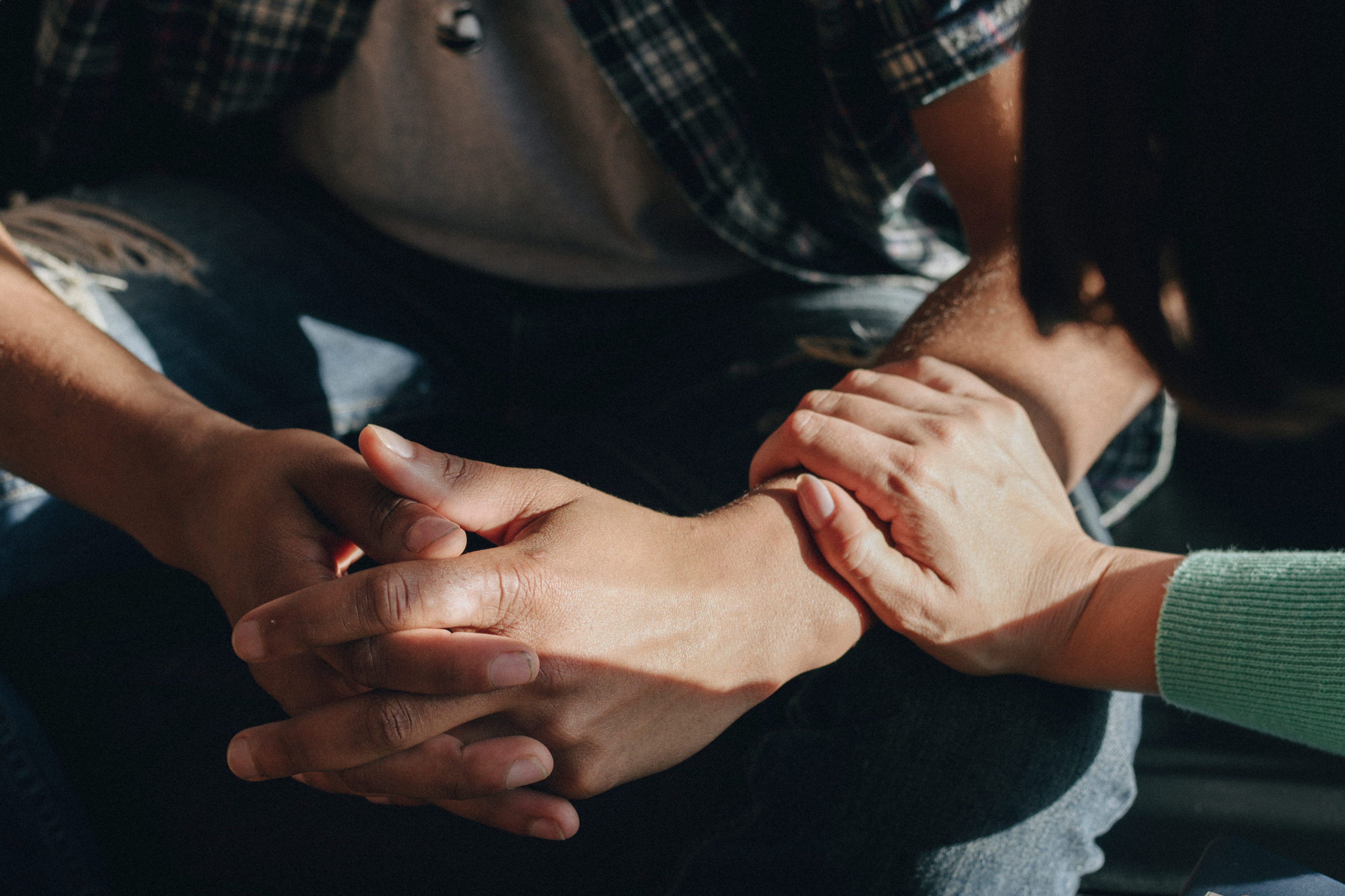 A persons hands on another persons arm