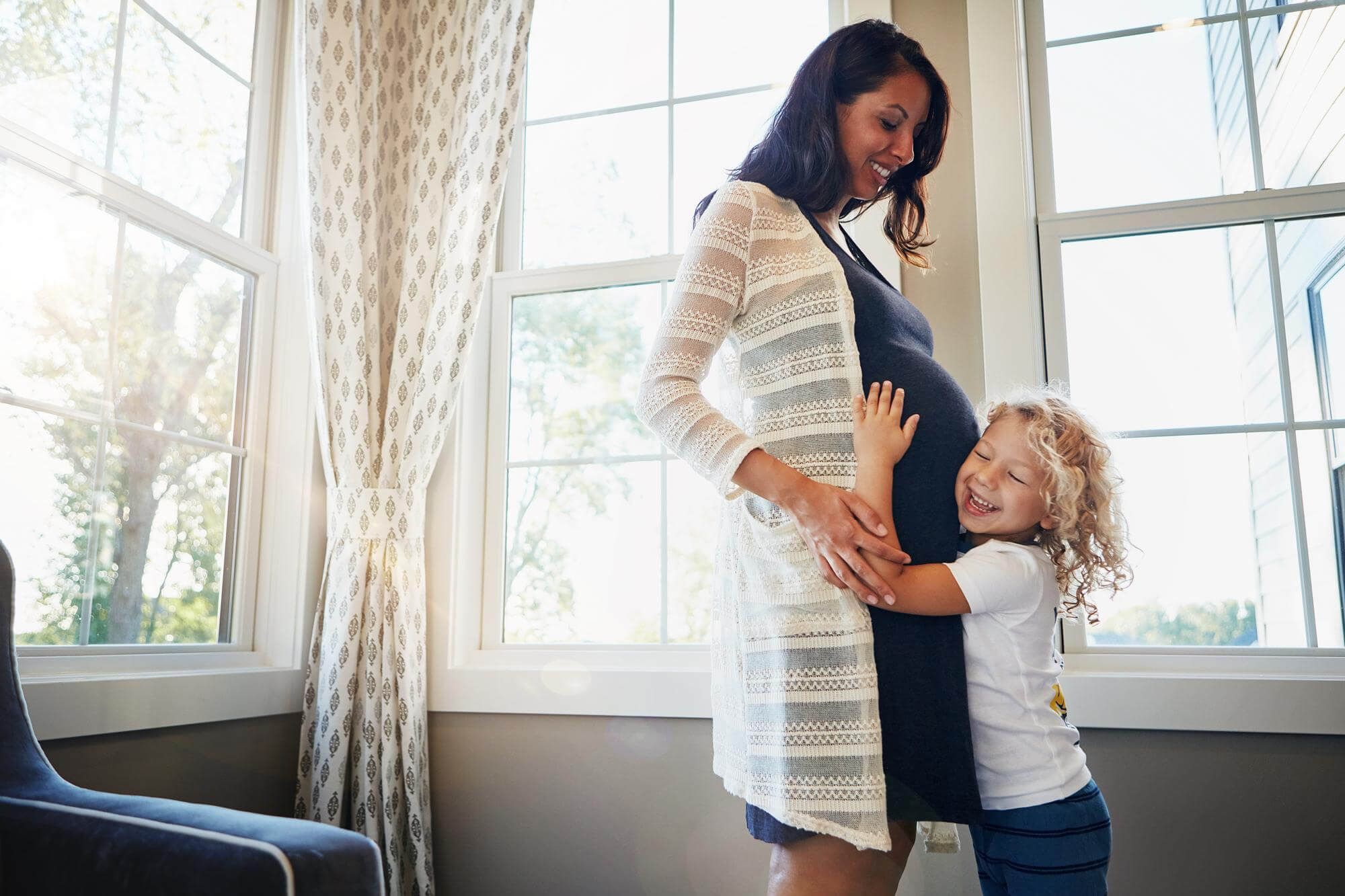 Pregnant Mom with a child hugger their belly