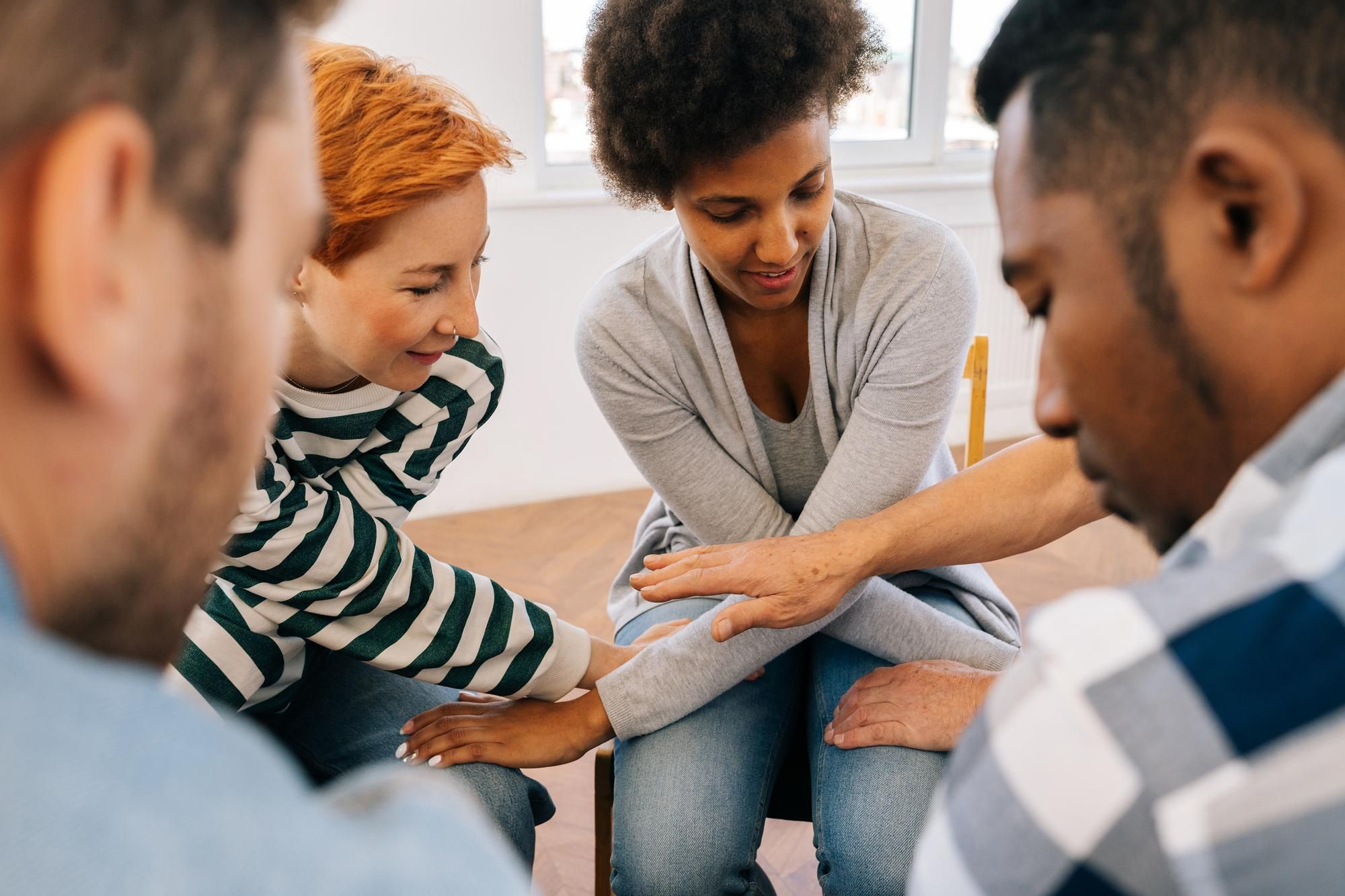 Group of people with their hands together in a circle